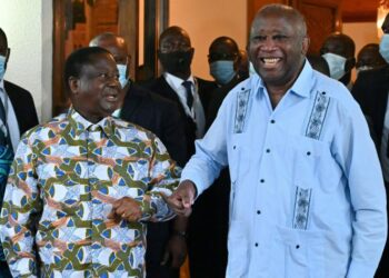 Former Ivorian presidents Henri Konan Bedie (L) welcomes Laurent Gbagbo (R) to his residence in the city of Daoukro in Ivory Coast on July 10, 2021. Three weeks after his return to the Ivory Coast, Laurent Gbagbo met with Henri Konan Bedie, at his residence in Daoukro, where the two leaders of the Ivorian opposition and former presidents intend to give a new impetus to the process of national reconciliation, while their respective parties fought during the crisis of 2010-2011.  / AFP / Issouf SANOGO
