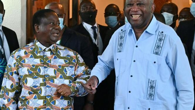 Former Ivorian presidents Henri Konan Bedie (L) welcomes Laurent Gbagbo (R) to his residence in the city of Daoukro in Ivory Coast on July 10, 2021. Three weeks after his return to the Ivory Coast, Laurent Gbagbo met with Henri Konan Bedie, at his residence in Daoukro, where the two leaders of the Ivorian opposition and former presidents intend to give a new impetus to the process of national reconciliation, while their respective parties fought during the crisis of 2010-2011.  / AFP / Issouf SANOGO