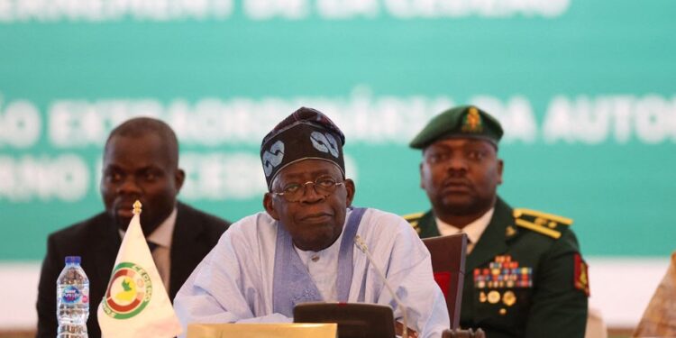 Chairperson of Economic Community of West African States (ECOWAS) and President of Nigeria, Bola Ahmed Tinubu, reacts while addressing the ECOWAS head of states and government, following Niger's military junta, in Abuja Nigeria on July 30, 2023. West African leaders were to meet on Sunday for a crisis summit on the coup in Niger, where protesters tried to storm the French embassy after the junta warned of an "imminent military intervention". In the third coup to fell a leader in Africa's restive Sahel region in as many years, Niger's elected president, Mohamed Bazoum, has been held by the military since Wednesday. (Photo by Kola SULAIMON / AFP)