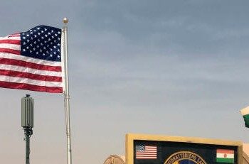 FILE - In this photo taken Monday, April 16, 2018, a U.S. and Niger flag are raised side by side at the base camp for air forces and other personnel supporting the construction of Niger Air Base 201 in Agadez, Niger. The U.S. says it has about 5,200 Africa Command personnel, troops and others, on the continent, plus about 800 other Department of Defense personnel. (AP Photo/Carley Petesch, File)
